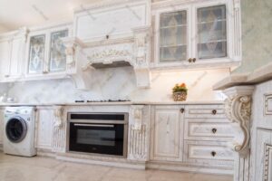 کابینت روکش چوب با طراحی کلاسیک و دستگیره‌های فلزی طلایی