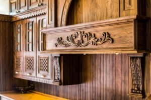 کابینت روکش چوب روشن با جزئیات منبت‌کاری و صفحه سنگ کرم